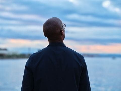 Man with glasses looking to the sky