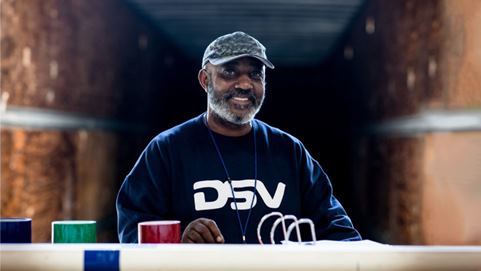 DSV warehouse worker smiling towards camera
