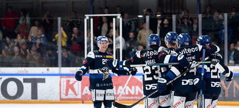 Players of HCC La Chaux de Fonds celebrating on the ice rink