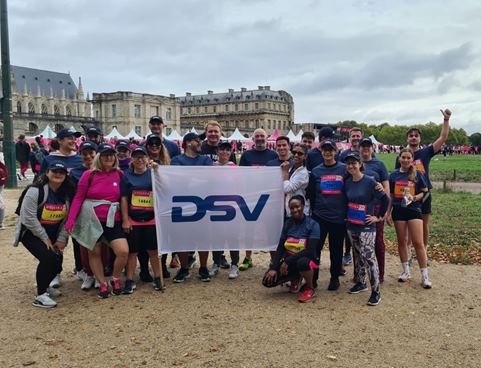 Groupe d'employés DSV avec drapeau DSV au château de Vincennes pour la course Odysseéa 2022.