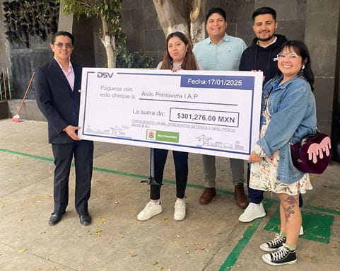El comite de DSV entregando el cheque al Director del Asilo Primavera