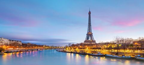 Eiffel Tower seen from the river in sun set