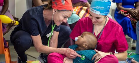 Volunteer nurse and doctor checking in on a child approved for free cleft surgery in Johannesburg