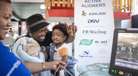 Cleft lip surgery recipient with her mom getting vitals checked before operation