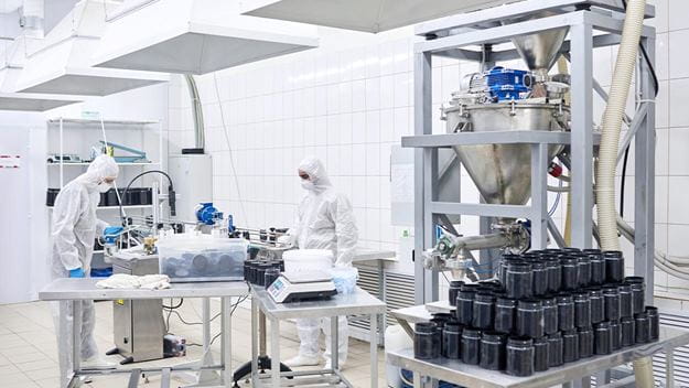 A team of highly professional staff wearing coveralls and safety masks taking pharmaceutical inventory in the DSV warehouse.
