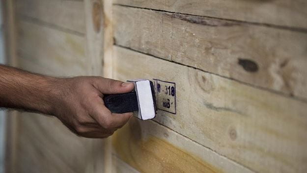 DSV staff is labeling wooden cargo.