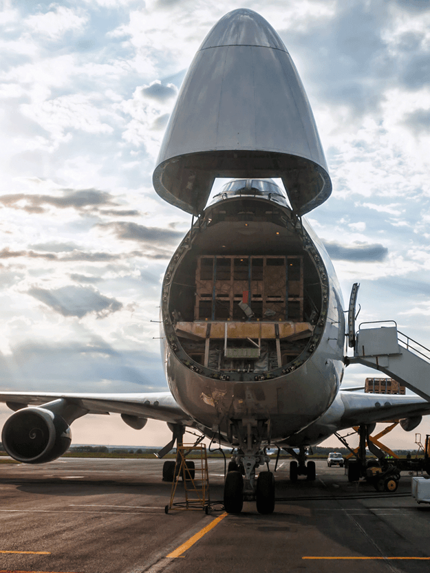Freight airplane with it's nose open standing on an airfield