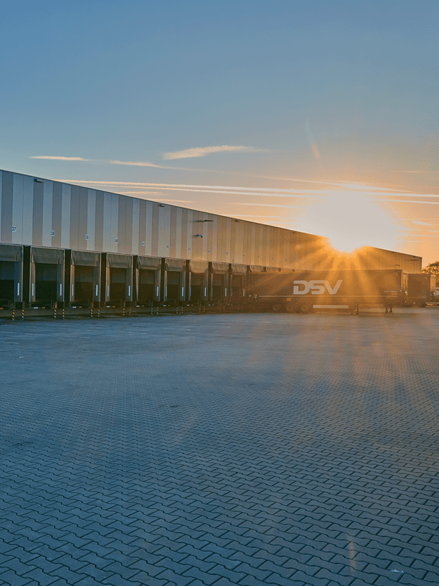outside view of a warehouse with sunset in the background