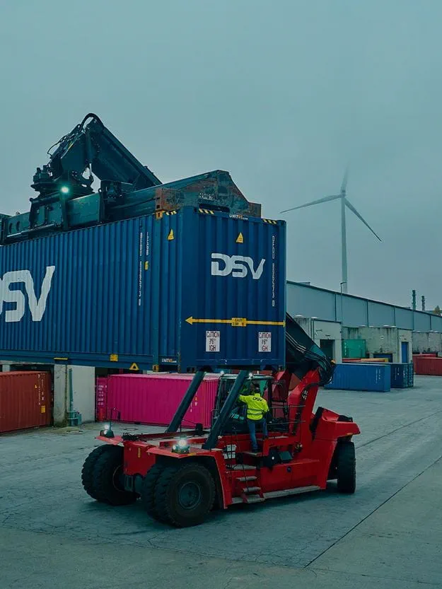 A DSV worker unloads a shipping container.