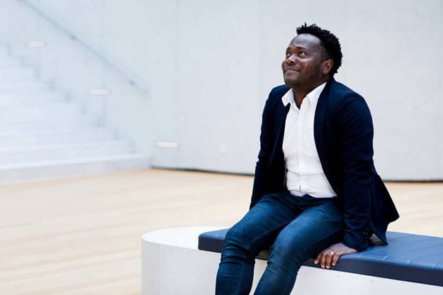 Male DSV employee sitting in the atrium at the DSV headquarter in Hedehusene