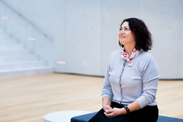 Female employee sitting in the atrium of the DSV headquarter in Hedehusene