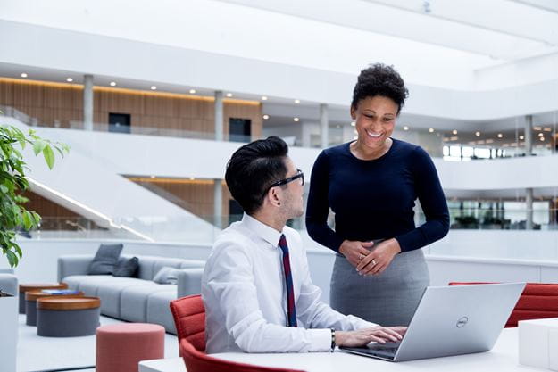 Male and female DSV employee looking at a computer screen