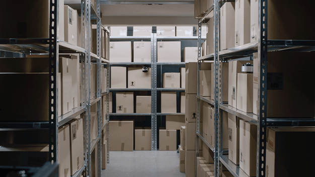 A DSV male employee with glasses delivering a parcel to a customer