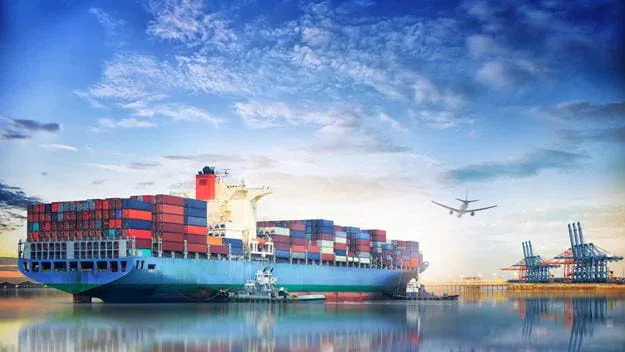 Container vessel in the ocean at port with airplane flying overhead