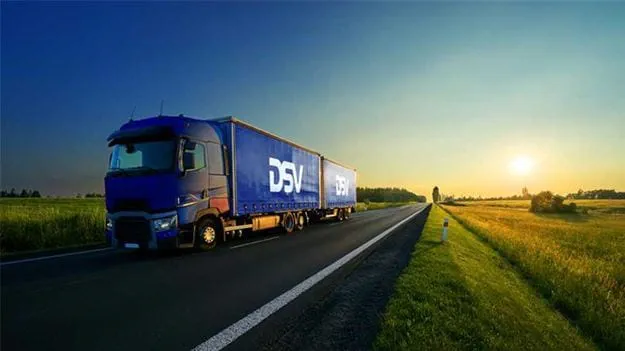 DSV truck on a highway at sunset, illustrating long-haul distribution and reliable delivery operations