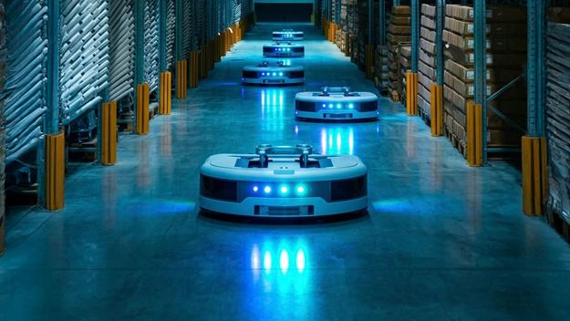 Autonomous mobile robots operating in a warehouse aisle, transporting goods efficiently with advanced automation