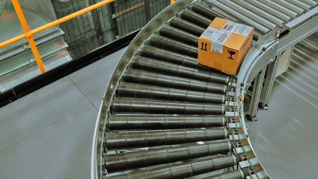 Package moving along an automated conveyor system inside a warehouse or distribution center.