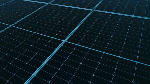 Close-up view of a large array of blue solar panels arranged in neat rows