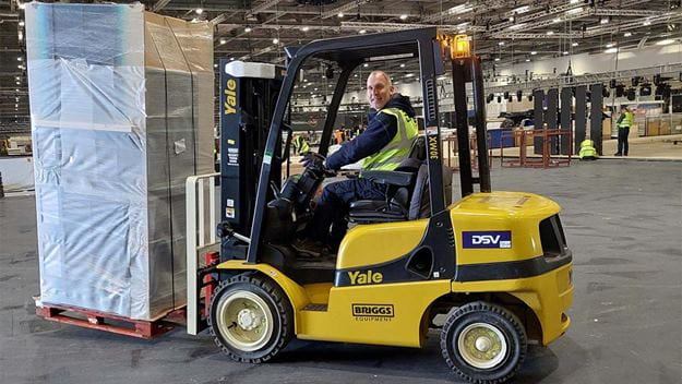 Fork lift moving pallets in a warehouse