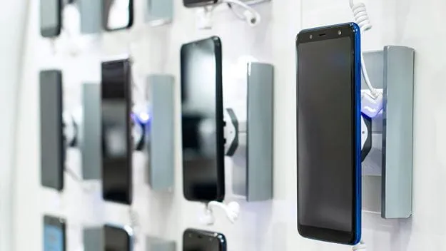 Mobile phones hanging on a wall for display