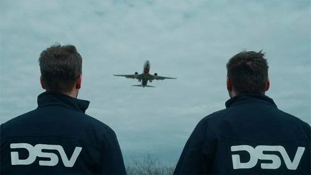 dsv transport and logistics two dsv employees watch air plane