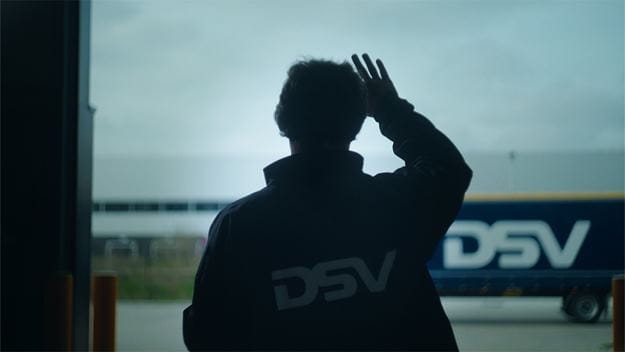 dsv transport and logistics dsv employee waves at truck
