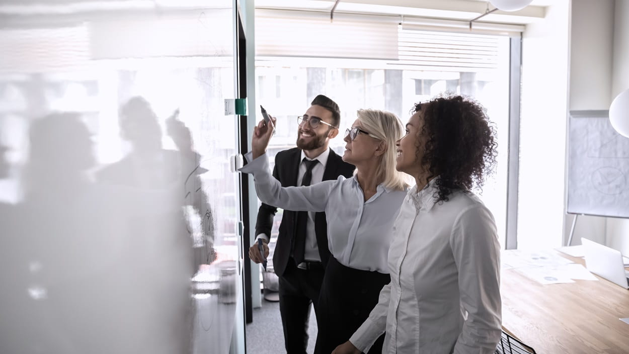 A man with a striped shirt is in a meeting.