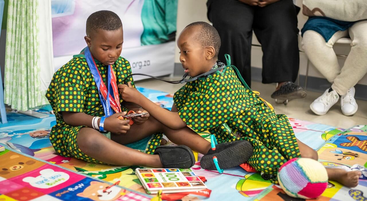 Two children scheduled for cleft surgery playing at Nelson Mandela Children's hospital