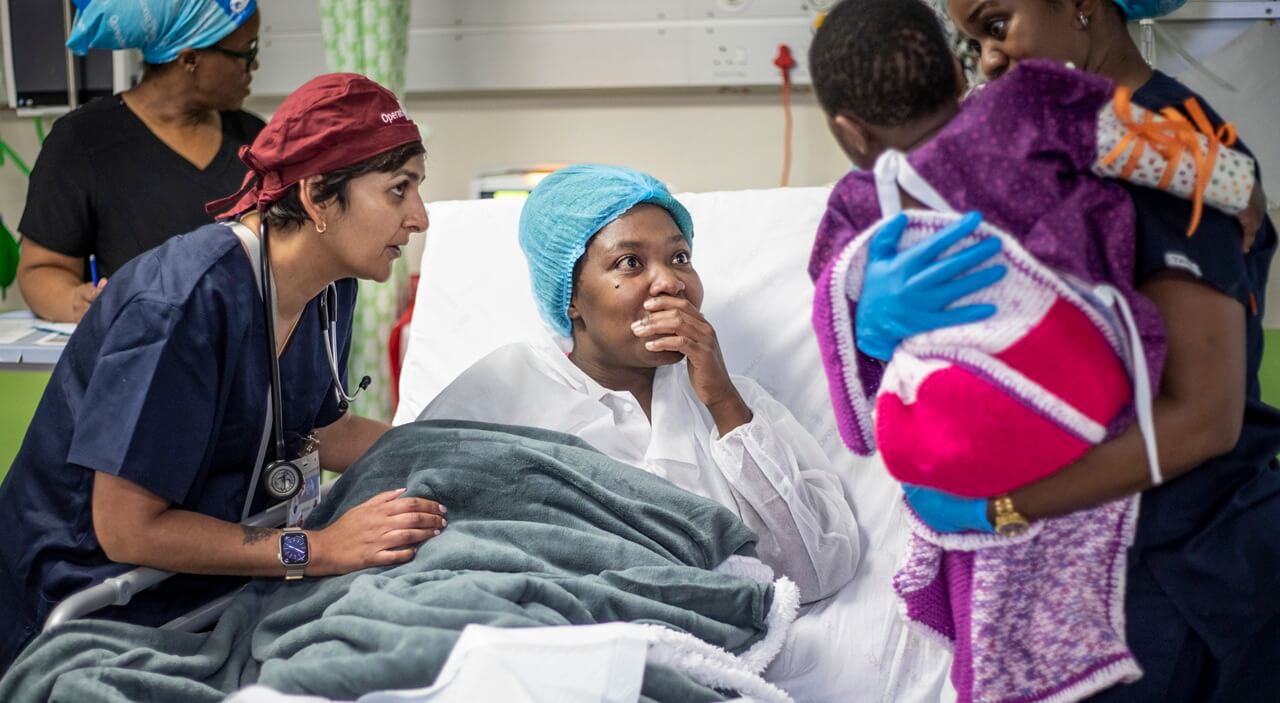 A mother seeing her child for the first time after cleft surgery