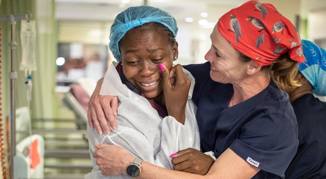 A happy mother receiving her child back from cleft surgery at Nelson Mandela Children's hospital