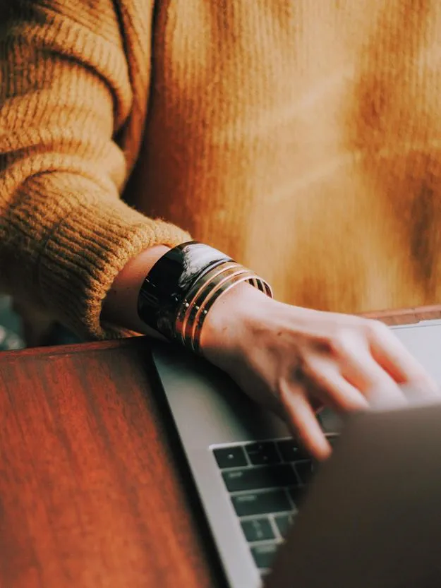 Woman typing on her laptop