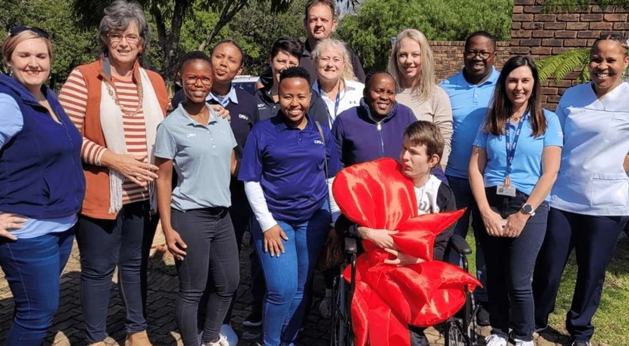 DSV hands over a wheelchair to a child with mobility challenges